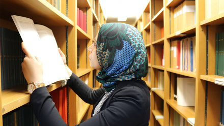 Noura reading in the library